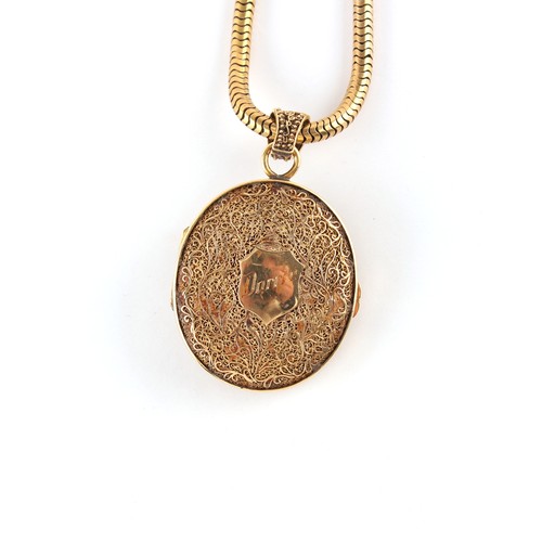 61 - Property of a gentleman - a Chinese 18ct yellow gold oval locket pendant with filigree Phoenix decor... 