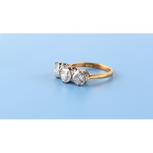 104 - Property of a lady - an 18ct yellow gold diamond three stone ring, the centre round brilliant cut di... 