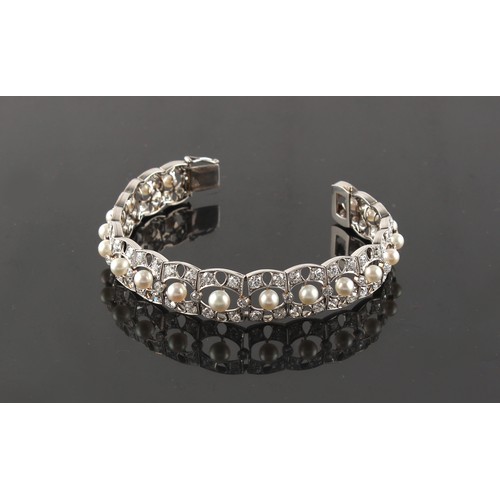 87 - A white gold diamond & pearl bracelet, circa 1915, the round brilliant cut diamonds weighing a total... 