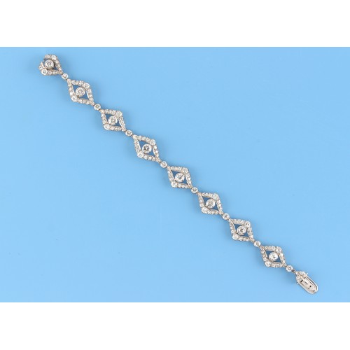 75 - A white gold diamond link bracelet, the round brilliant cut diamonds weighing a total of approximate... 