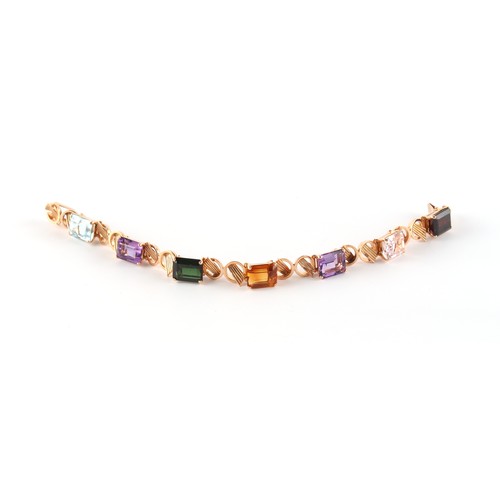 79 - An unmarked 14ct gold (tested) multi gem set bracelet, the seven rectangular cut gemstones including... 