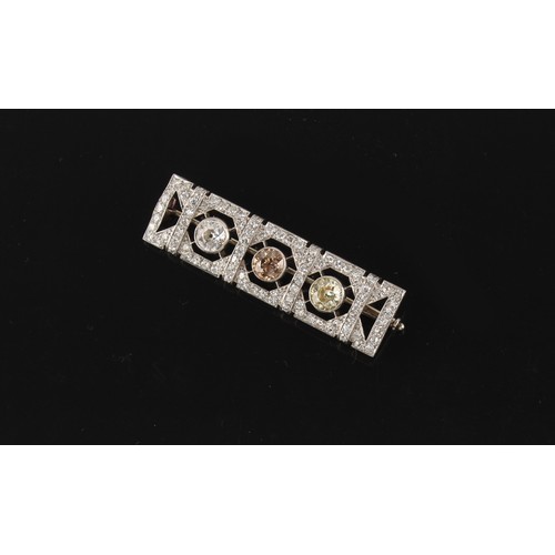 89 - An Art Deco fancy coloured diamond & white diamond rectangular panel brooch, set with a fancy pale p... 