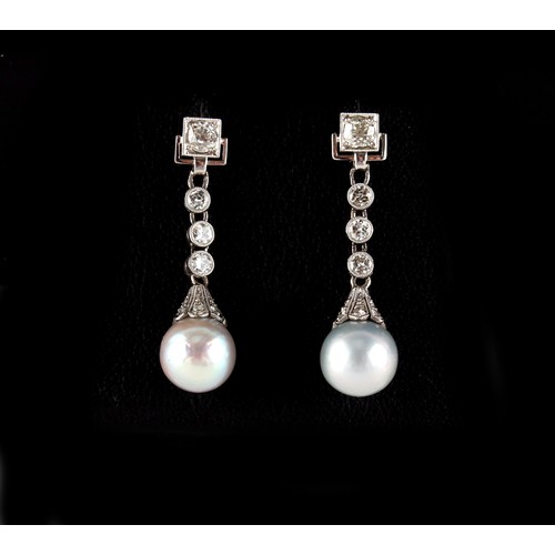 53 - A pair of unmarked white gold pearl & diamond pendant earrings, with post & butterfly fastenings, ea... 