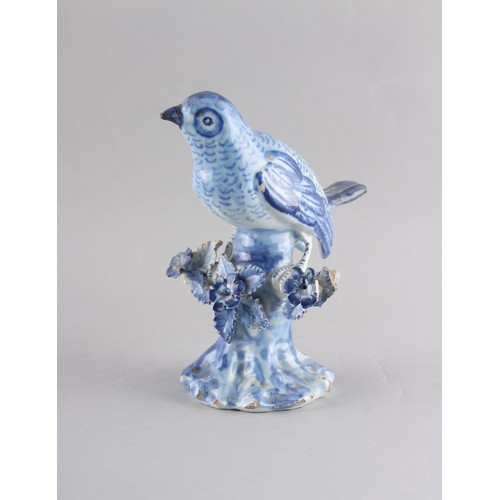 125 - Property of a deceased estate - a late 18th century Dutch Delft blue & white model of a bird perched... 