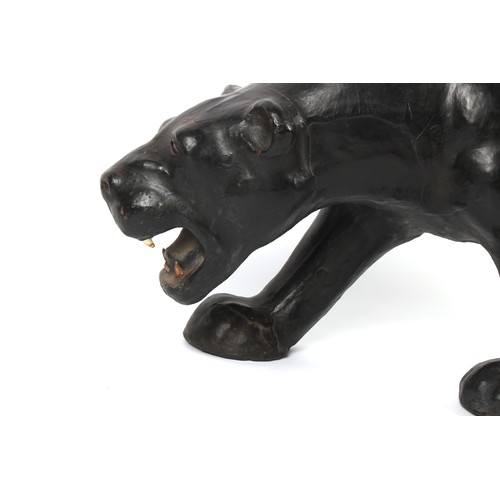 73A - A Liberty style leather model of a panther, 53.5ins. (136cms.) long.