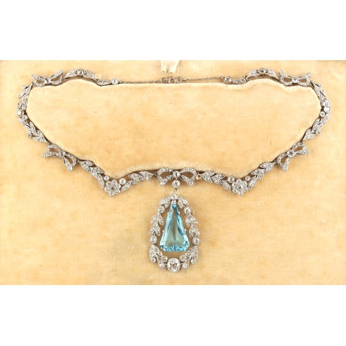 148 - A fine Belle Epoque aquamarine & diamond necklace, the angular drop shaped aquamarine of intense vib... 