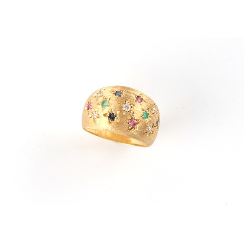 32 - A modern Italian 18ct gold multi gem set ring of textured form set with diamonds, rubies, emeralds &... 