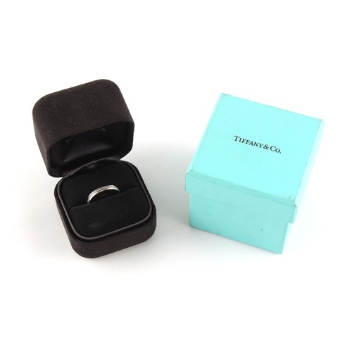 75 - Tiffany & Co. - an 18ct white gold diamond eternity ring, size K, in original box & outer box.