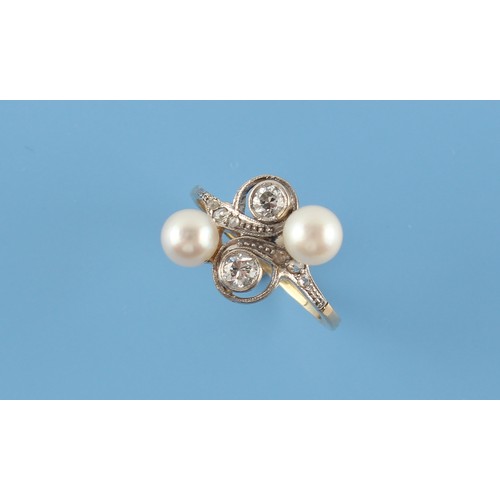 88 - An unmarked yellow gold pearl & diamond crossover ring, with two round brilliant cut diamonds in mil... 