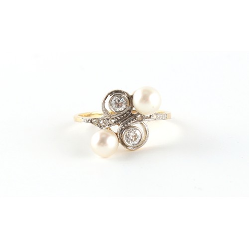 88 - An unmarked yellow gold pearl & diamond crossover ring, with two round brilliant cut diamonds in mil... 