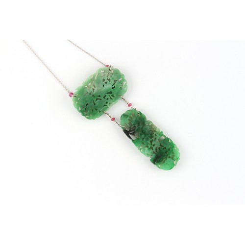 85 - A Chinese carved jadeite necklace composed of two jadeite panels carved with fruit & leaves, linked ... 