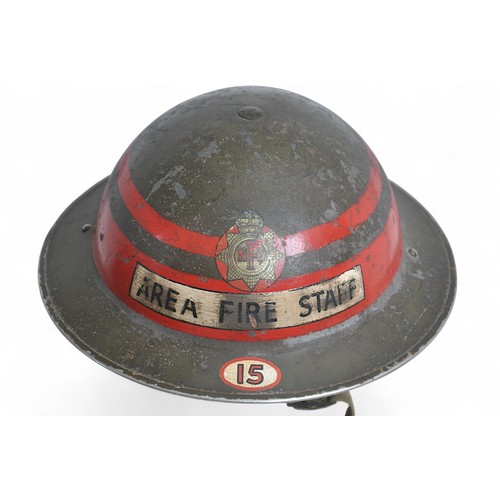 WW2 British Home Front 'Area Fire Staff' NFS Helmet. Senior ranking HQ staff MkII steel helmet of the National Fire Service with double bands ( One thicker than the other) for rank of senior company commander. Black lettering on white bar to front of helmet. Each chinstrap lug is dated 1938 with liner cradle having maker name & date 'JCS & W Ltd 1938'. Web chinstrap intact.