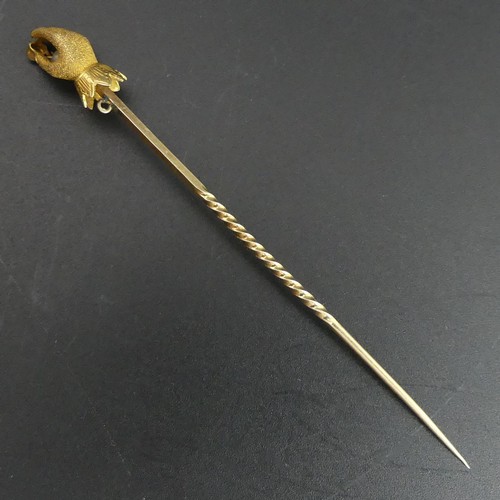 26 - Victorian gold stick pin with a diamond and pearl hand end. 2.2 grams. 72mm long (Hand 13mm).