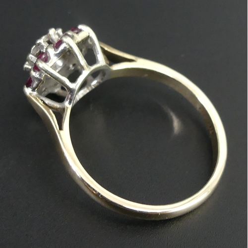 72 - 9ct gold ruby and diamond cluster ring, London 1979. Size N 1/2. Band 2mm Head 11.3mm. 3 grams.