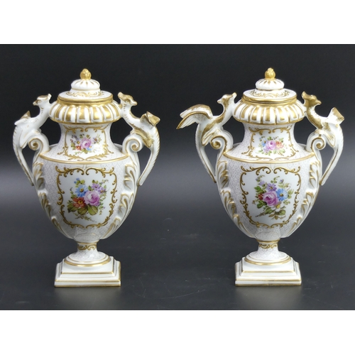 100 - A pair of 19th century German hand painted porcelain vases and covers. 19.5cm high.