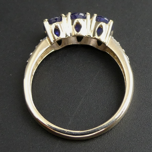 124 - 9 carat gold tanzanite and diamond ring. Size 'O 1/2' top 6.5mm. 2.2 grams.