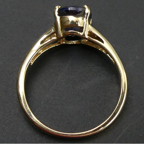 149 - 18ct gold tanzanite single stone ring. Size 'N'. 9.1mm wide. 3.8 grams.