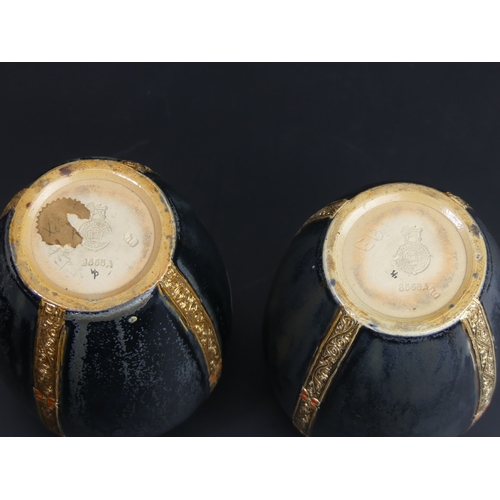 88 - A pair of Royal Doulton black, gold and coral pottery vases, Ethel Beard monogram. 17cm tall.