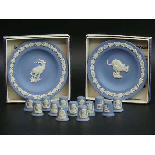 217 - 13 Wedgwood blue jasper ware thimbles and two boxed pin trays.