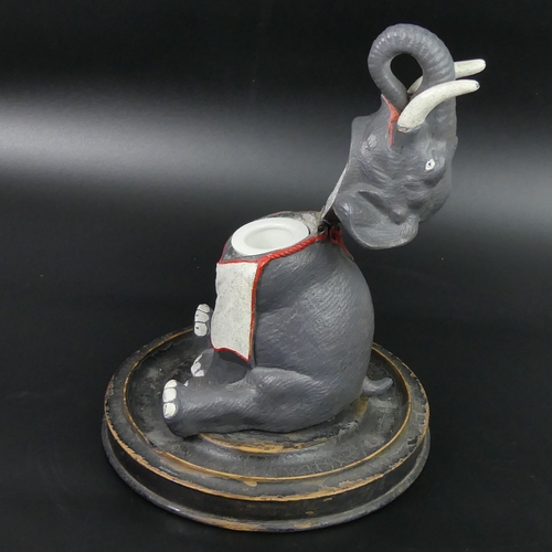 76 - Late Victorian painted spelter elephant form inkwell on an ebonised wooden base. 16.3 cm in diameter... 