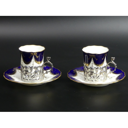 81 - A pair of Coalport silver mounted cabinet cups and saucers. Chester 1911. Cup 68 mm high. Saucer 120... 