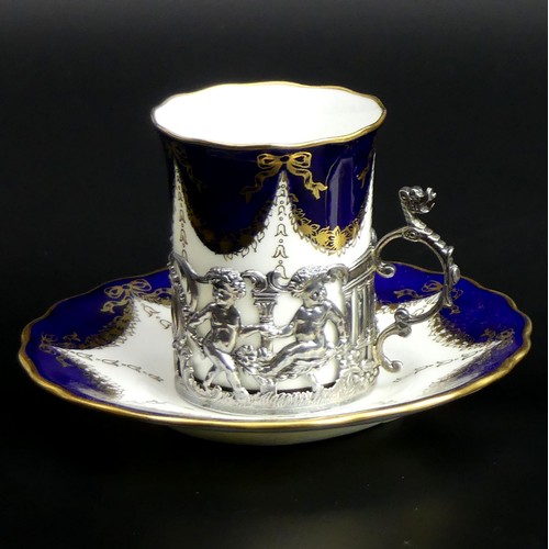 81 - A pair of Coalport silver mounted cabinet cups and saucers. Chester 1911. Cup 68 mm high. Saucer 120... 