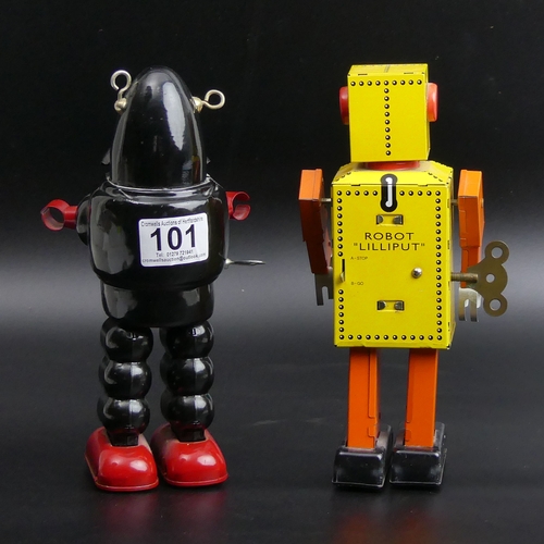 101 - Two tin plate clock work toy robots. 22 cm tall. UK Postage £15.