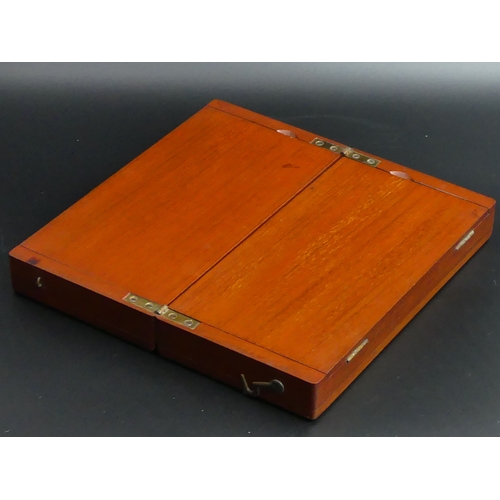 169 - A mahogany cased travelling chess set of quality, circa 1910. 50 x 25 cm when open. UK Postage £20.