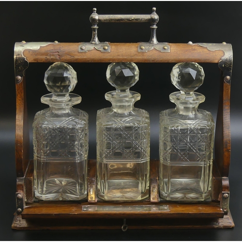 214 - Victorian oak tantalus with three hobnail cut glass spirit decanters. 36 x 36 13 cm. UK Postage £30.