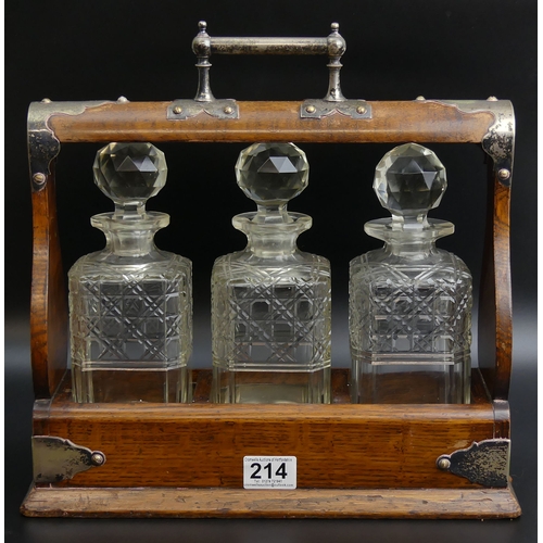 214 - Victorian oak tantalus with three hobnail cut glass spirit decanters. 36 x 36 13 cm. UK Postage £30.