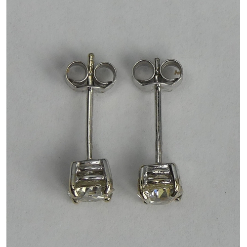 118 - A pair of 18ct white gold diamond earrings (approx. 1ct in total). 1.3 grams. 5.4 mm diameter. UK Po... 