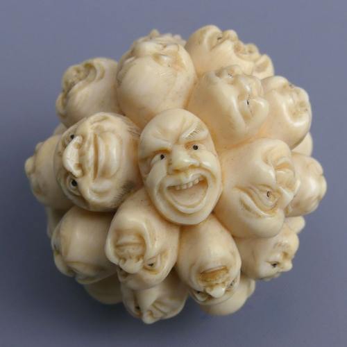 267 - Meiji period Japanese ivory Okimono depicting many carved heads all with different faces, (un-signed... 