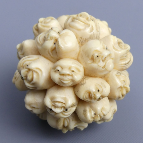 267 - Meiji period Japanese ivory Okimono depicting many carved heads all with different faces, (un-signed... 