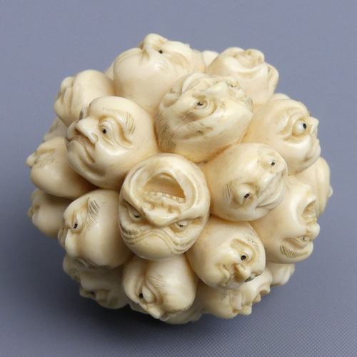 267 - Meiji period Japanese ivory Okimono depicting many carved heads all with different faces, (un-signed... 