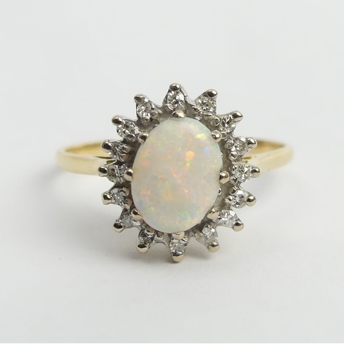 11 - 18ct gold opal and diamond cluster ring, 4.6 grams. Size W, 14.2 grams. UK Postage £12.