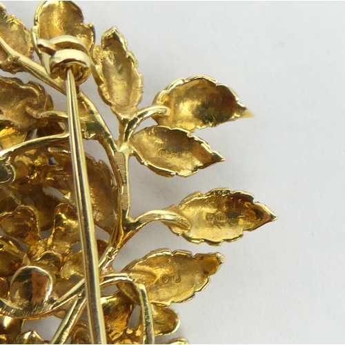 7 - 18ct gold sapphire set floral design brooch, London 1989, 16 grams. 54 x 38 mm. UK Postage £12.