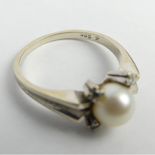8 - 14ct white gold cultured pearl and diamond ring, along with an unmarked example. 5.6 grams. Q 1/2 & ... 