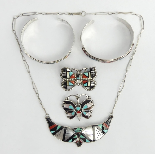 25 - Five items of Native American silver jewellery, viz. two brooch/pendants, two bangles and a necklace... 
