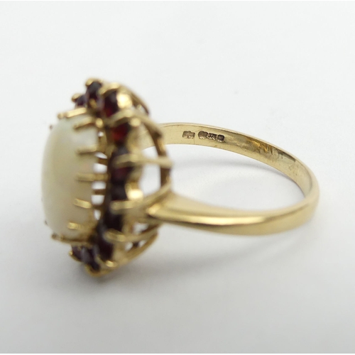 26 - 9ct gold opal and garnet cluster ring, 4.2 grams. Size N, 17.7 mm. UK Postage £12.