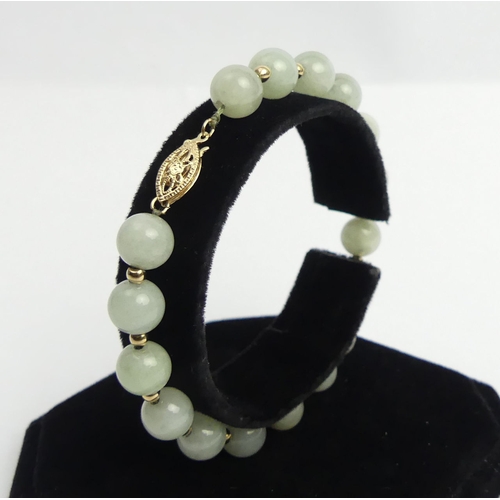 28 - 14ct gold and jade bead bracelet, 16.7 grams. 190 x 8.3 mm. UK Postage £12.