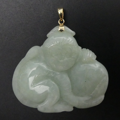 30 - Carved jade monkey and peach 14ct gold mounted pendant, 27 grams. 43 x 47 mm. UK Postage £12.