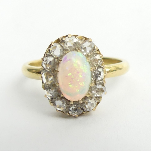 44 - 18ct gold opal and diamond oval cluster ring, 3.4 grams. Size L, 13.8 x 11.1 mm. UK Postage £12.