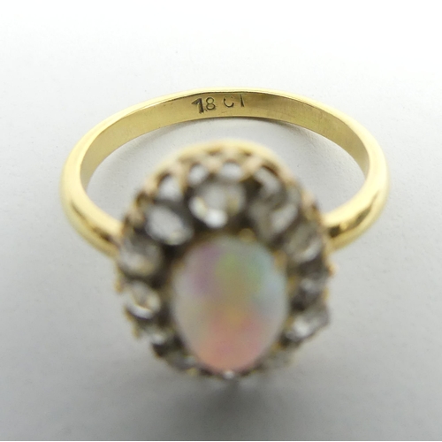 44 - 18ct gold opal and diamond oval cluster ring, 3.4 grams. Size L, 13.8 x 11.1 mm. UK Postage £12.