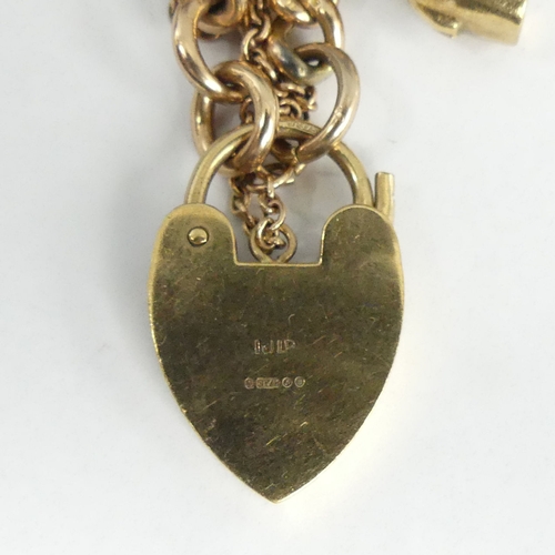 45a - 9ct gold curb link charm bracelet with a spade guinea and 1/2 sovereign, 67 grams. UK Postage £12.