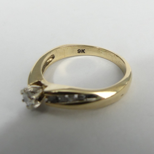 6 - 9ct gold diamond twist ring, 2.9 grams, approx .25ct total. Size M, 4.6 mm. UK Postage £12.