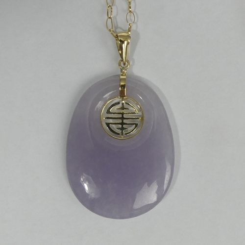 8 - 9ct gold and purple jade pendant and chain, 8.7 grams. 42 x 25 mm. UK Postage £12.