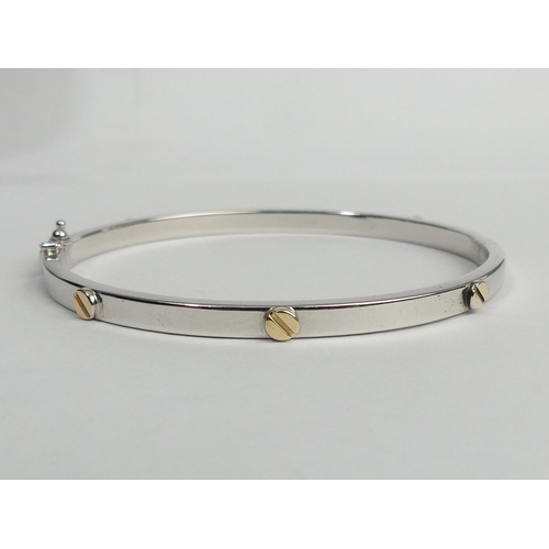 9 - 9ct white and yellow gold hinged bangle, 7.7 grams. 4.3 mm wide. UK Postage £12.