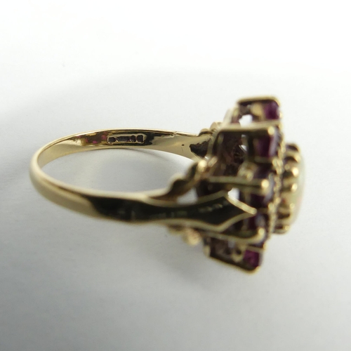 35 - 9ct gold opal and ruby ring, 3.5 grams. Size N 1/2, 15.8 mm. UK Postage £12.