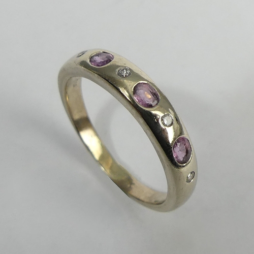 64 - 9ct gold diamond and pink topaz seven stone ring, 2.7 grams. Size P, 4.1 mm. UK Postage £12.