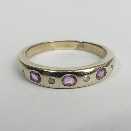 64 - 9ct gold diamond and pink topaz seven stone ring, 2.7 grams. Size P, 4.1 mm. UK Postage £12.